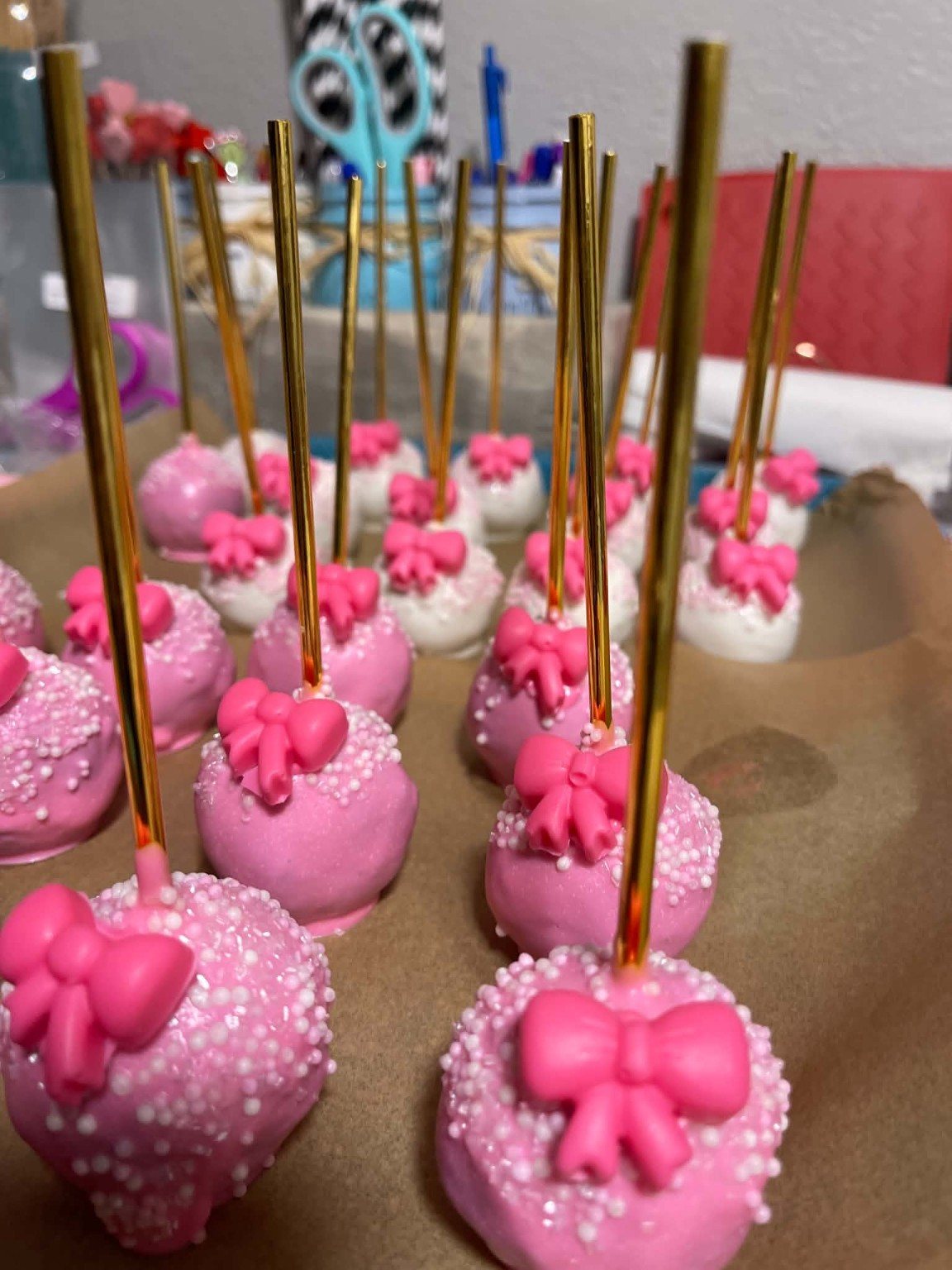 Custom pink bow cake pop order in progress