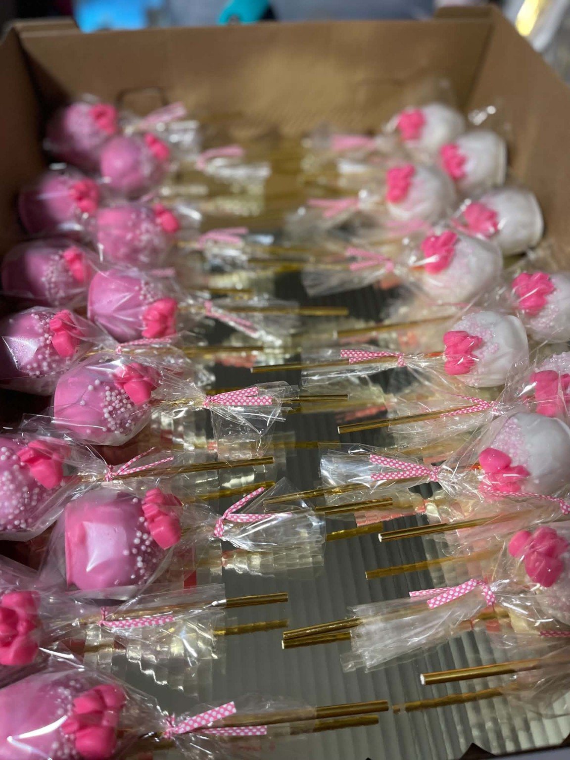 Individually wrapped pink and white bow cake pops