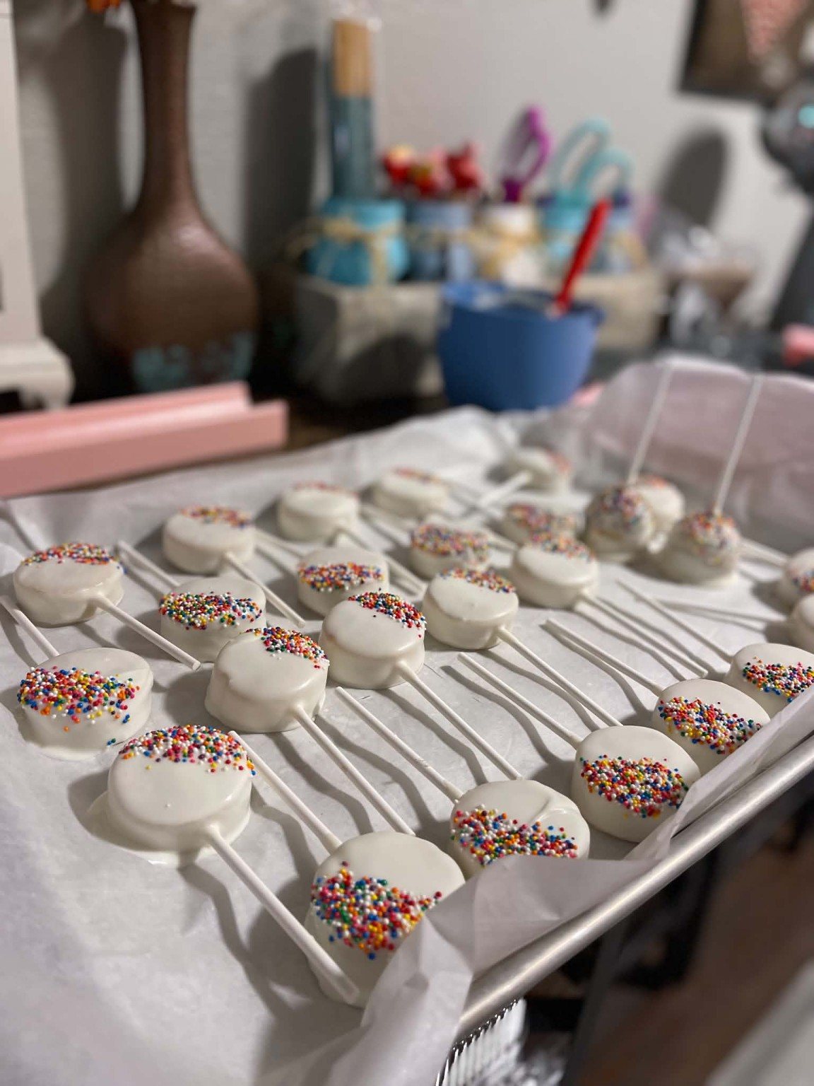 White cake pops with bright rainbow sprinkles